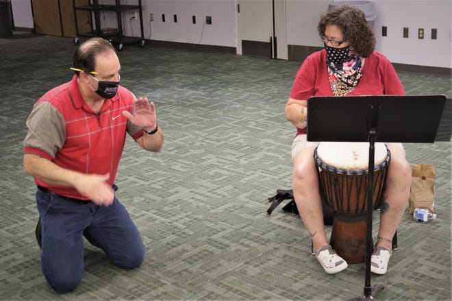 San Juan College music professor Teun Fetz demonstrates a technique for student Madeline Martinez during his Aug. 24, 2020, African drumming class on the college campus in Farmington.