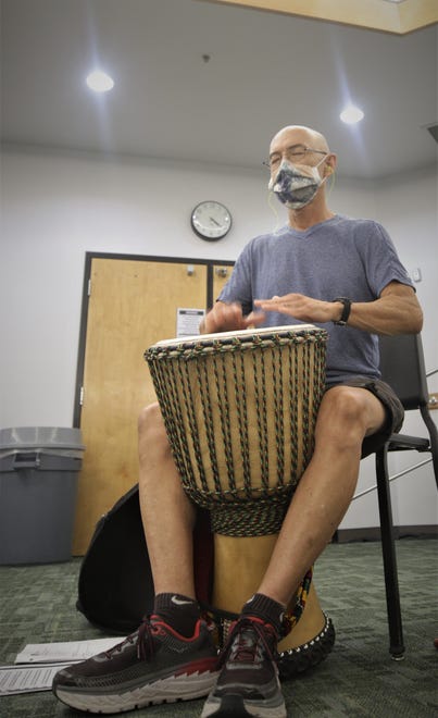 Student Charlie Higby plays a djembe during an African drumming class on Aug. 24, 2020, on the San Juan College campus in Farmington.
