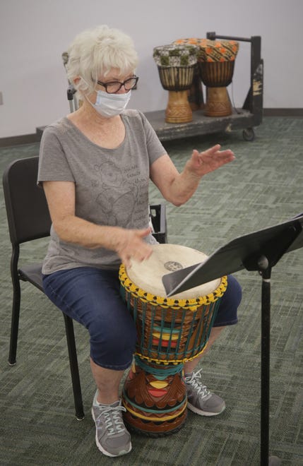 Student Martha Wilson pounds her djembe during an African drumming class on the San Juan College campus in Farmington on Aug. 24, 2020.
