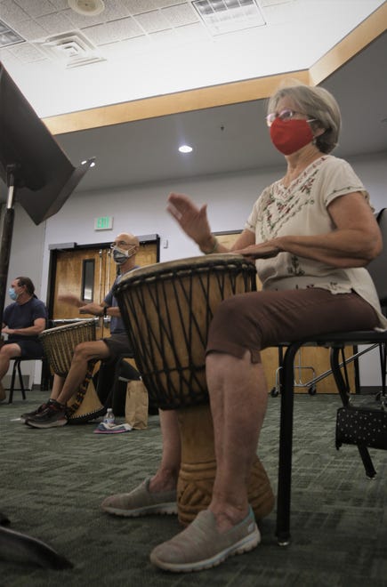 June Bayard follows the lead of instructor Teun Fetz in an African drumming class on the San Juan College campus in Farmington on Aug. 24, 2020.