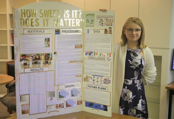 Tibbetts Middle School eighth-grader Alex Bessinger displays the science project that helped her become a semifinalist in a national STEM competition.