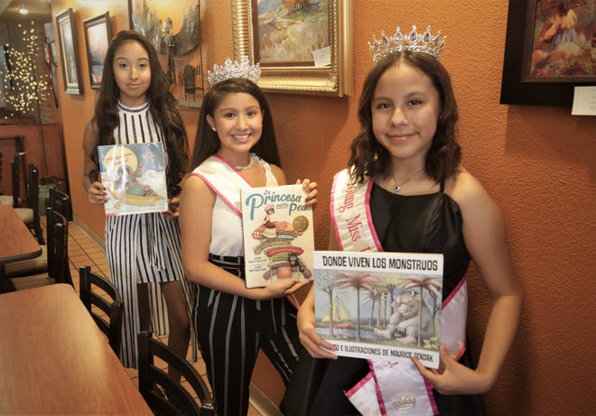 Isabela Esperanza Teresa Gonzalez, left, Gabriela Aranza Teresa Gonzalez and Brianna Marie Pena Begay display some of the stories they'll be reading during the inaugural Hispanic Heritage Virtual Youth Storytelling event next weekend.