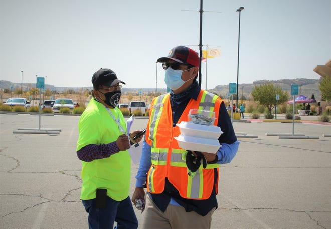 At left, Arbin Mitchell, who supervises the tribe's 2020 Census office, and Navajo Nation President Jonathan Nez finish talking about the response to the census and food distribution event on Sept. 19 at Northern Edge Casino in Upper Fruitland.