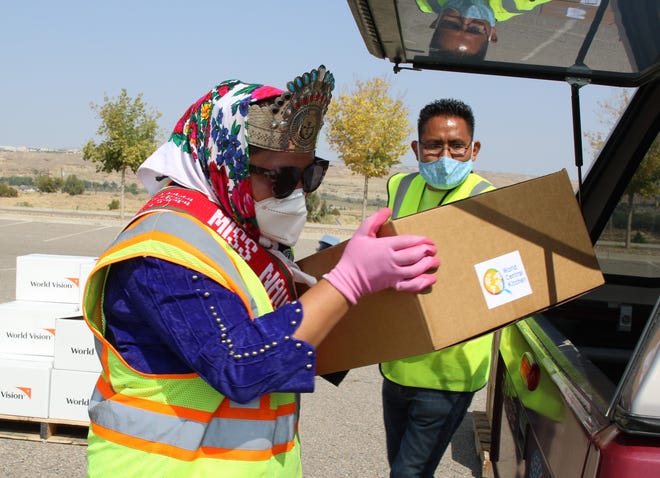 Miss Navajo Nation Shaandiin Parrish loads a box of food on Sept. 19. The Navajo Nation president's office distributed food and supplies during the 2020 Census event at Northern Edge Casino in Upper Fruitland.