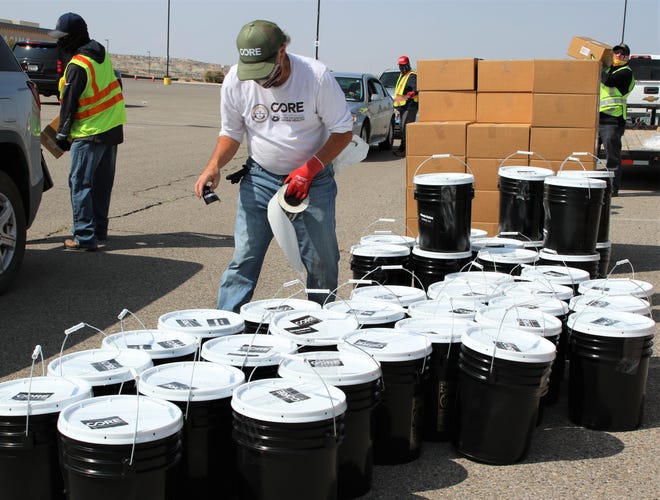 Steve Diminuco, who oversees hygiene kits distribution on the Navajo Nation for the non-profit organization CORE, applies stickers to the containers on Sept. 19. CORE distributed the items during the 2020 Census event at Northern Edge Casino in Upper Fruitland.