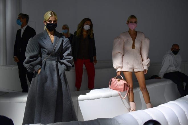 Signs of the time. Guests wore face masks and respected social distances prior to Fendi's Spring/Summer 2021 show.