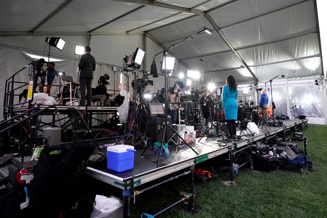 Broadcast journalists stand inside a tent outside the Health Education Campus of Case Western Reserve University ahead of the first presidential debate between Republican candidate President Donald Trump and Democratic candidate former Vice President Joe Biden.