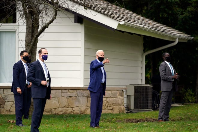 Democratic presidential candidate former Vice President Joe Biden talks to neighbors as he arrives at a private home in Cleveland.