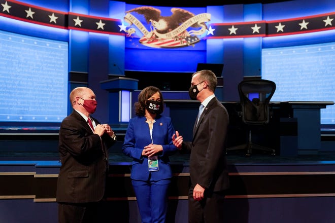 From L-r., Rep. Chris Coons, D-Del., Rep. Lisa Rochester, D-Del., and Mayor of Los Angeles, Eric Garcetti, talking before taking their seats before the start of the first presidential debate.