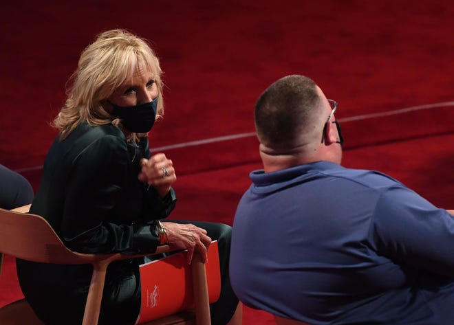 Wife of former US Vice President Joe Biden, Jill Biden speaks to a seat mate during the first presidential debate.