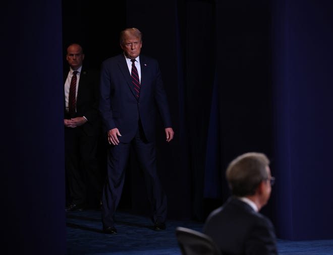 U.S. President Donald Trump walks on the stage in the first presidential debate.