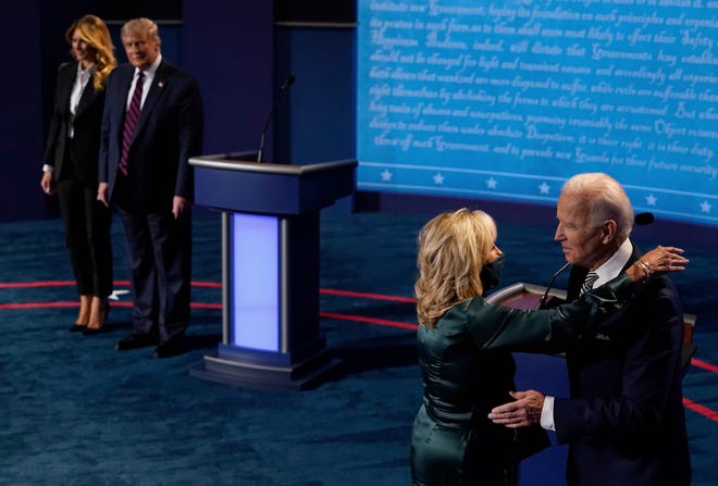 First Lady Melania Trump and President Donald Trump look on as Democratic Presidential candidate and former Vice President Joe Biden hugs his wife Jill Biden after the first presidential debate at Case Western Reserve University and Cleveland Clinic in Cleveland, Ohio, on Sept. 29, 2020.