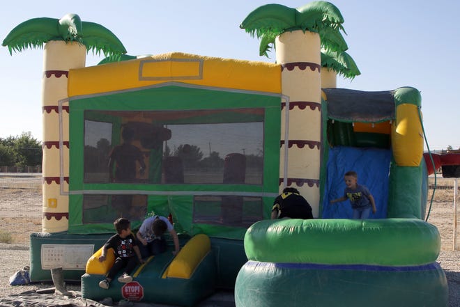 Kids play in an inflatable castle at the Carlsbad Yoga Barr in Otis on Oct. 10, 2020.  Carlsbad Yoga Barr had its grand opening and had activities for children while the adults did a session of yoga.