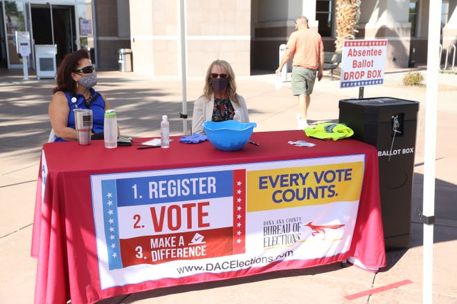 Two Doña Ana County Clerk document technicians, Patricia Triolo and Patti Scarborough, monitor the absentee ballot drop box location at the Doña Ana County Government Center on Wednesday, Oct. 14, 2020.