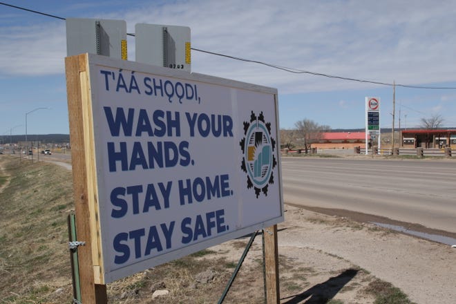A sign reminds motorists on Arizona Highway 264 in Window Rock, Arizona on March 29 to use precautions to prevent the spread of COVID-19 in communities.