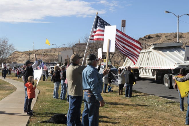 Demonstrators gather along the sidewalk in front of Animas Valley Mall, Saturday, Nov. 21, 2020, to protest the public health orders intended to prevent the spread of COVID-19.
