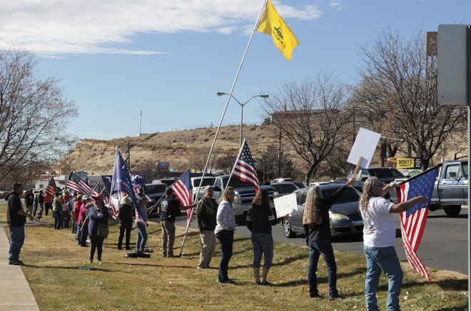 San Juan County residents protest the public health orders intended to prevent the spread of COVID-19, Saturday, Nov. 21, 2020, in Farmington.