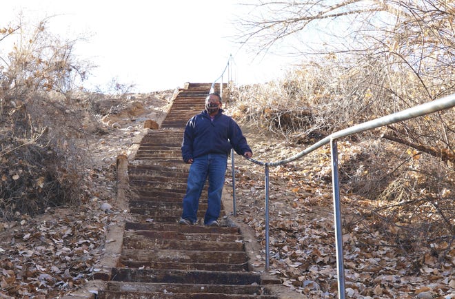 Arthur Bavaro, community services coordinator at Nenahnezad Chapter, stands on Dec. 9, 2020 on the staircase that is part of the new recreational trail in Nenahnezad.