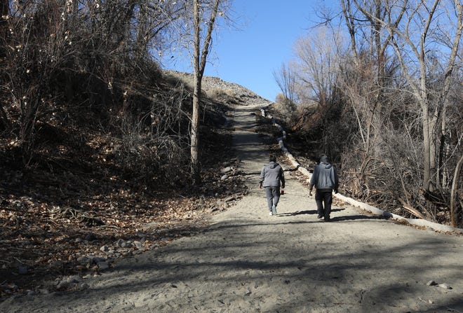 Community members walk on the new recreational trail on Dec. 9, 2020 in Nenahnezad.
