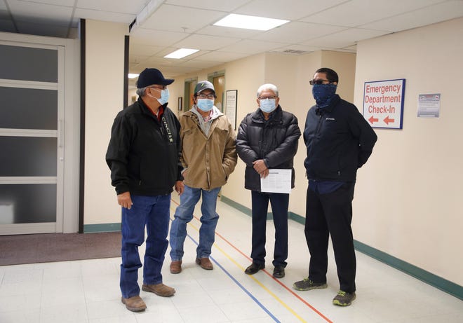 From left, Navajo Nation Council delegates Paul Begay, Jimmy Yellowhair and Edison Wauneka and Navajo Nation President Jonathan Nez wait inside Gallup Indian Medical Center on Dec. 31, 2020 in Gallup.