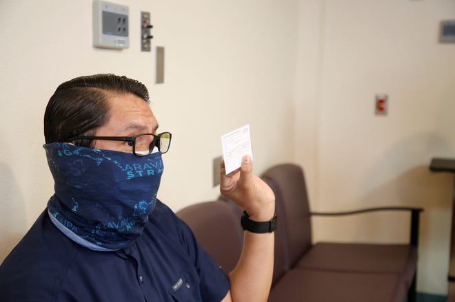 Navajo Nation President Jonathan Nez shows his vaccination card for COVID-19 on Dec. 31, 2020. Nez was among Navajo leaders to receive the Pfizer-BioNTech COVID-19 vaccine during a livestream from Gallup Indian Medical Center in Gallup.