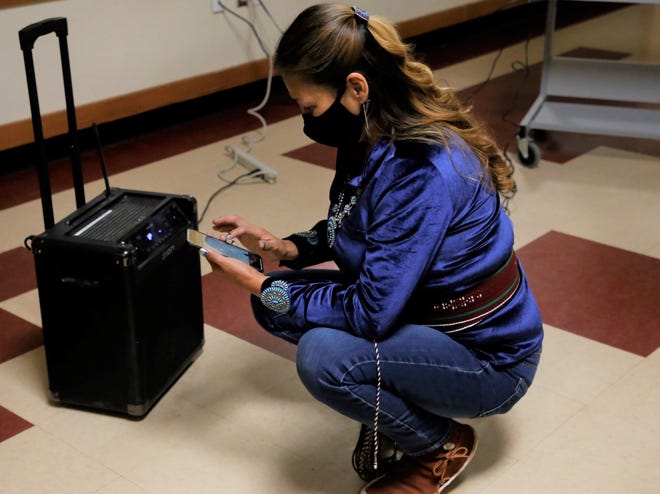 Lisa Marie Byrd tries to connect her smartphone to a bluetooth speaker so elected officials can listen to the virtual Navajo Nation chapter government inauguration on Jan. 6 in Upper Fruitland. Byrd was elected vice president of Upper Fruitland Chapter.