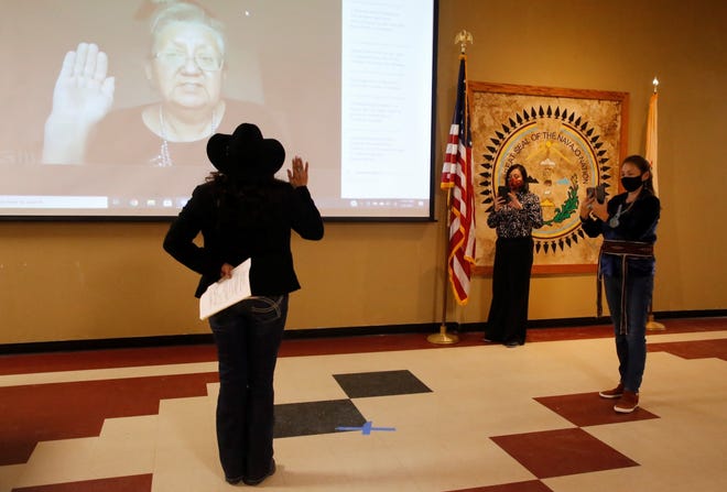 Roxanne R. Lee, left, takes the oath of office for the grazing official at Upper Fruitland Chapter during the virtual Navajo Nation chapter government inauguration on Jan. 6. The elected officials participated in the event from the chapter house in Upper Fruitland.
