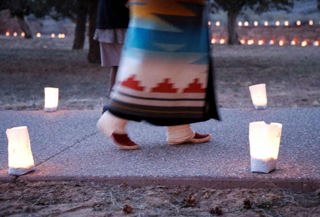 Miss Navajo Nation Shaandiin Parrish walks by luminarias as part of tribute to tribal members who died of COVID-19 in an event on March 17 in Window Rock, Arizona.