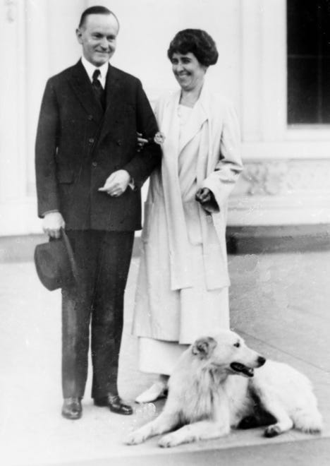 President Calvin Coolidge and first lady Grace Coolidge  with their dog at the White House portico in 1924.