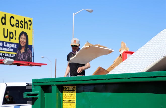 Levi Tan discards debris from a house remodel at the City of Farmington's Spring Dumpster Weekend on April 10 at Berg Park in Farmington.