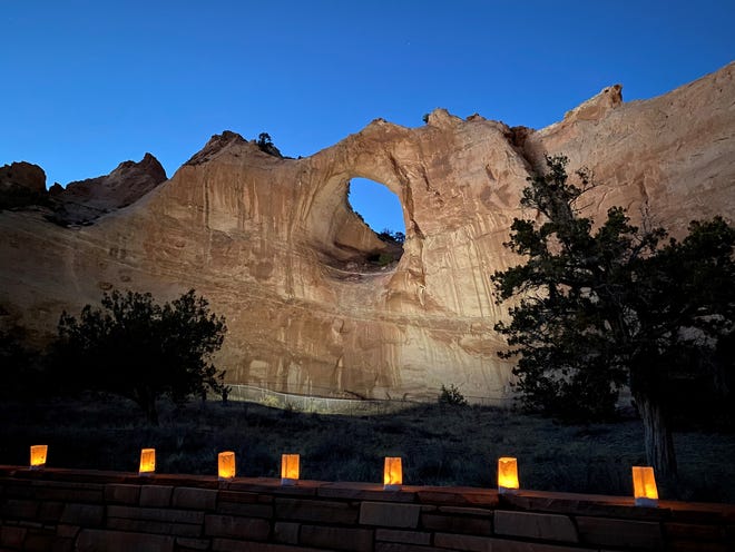 The Window Rock formation is illuminated on March 17 in tribute to members of the Navajo Nation who died of COVID-19.