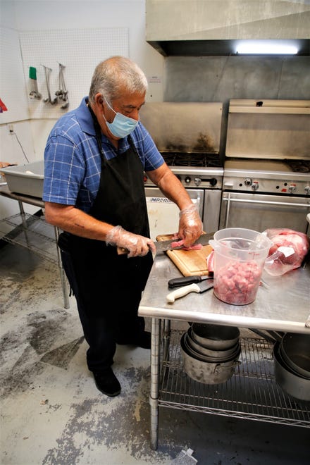 Fernando Reyes slices pork in the kitchen at Chambers Steakhouse in Bloomfield on April 13, 2021.