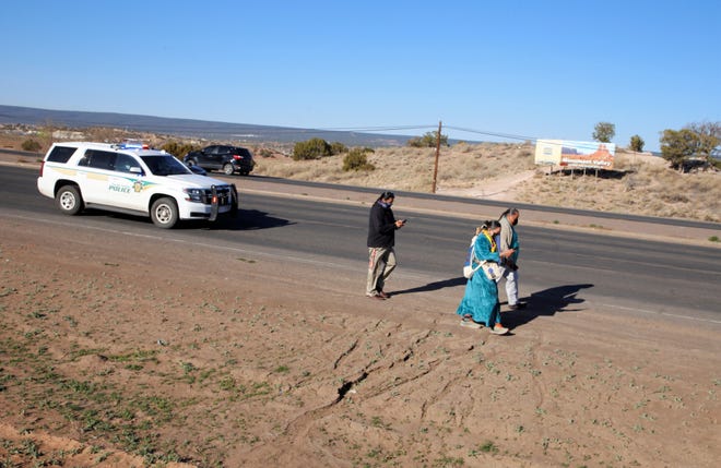 A walk centering on sexual assault awareness and prevention on April 19 proceeds on Navajo Route 12 in Window Rock, Arizona.