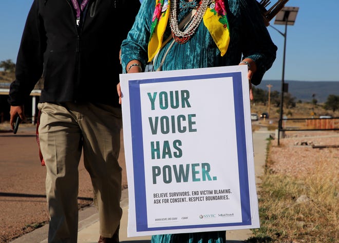 Delegate Amber Kanazbah Crotty carries a message aimed at survivors of sexual assault during an awareness walk on April 19 in Window Rock, Arizona.