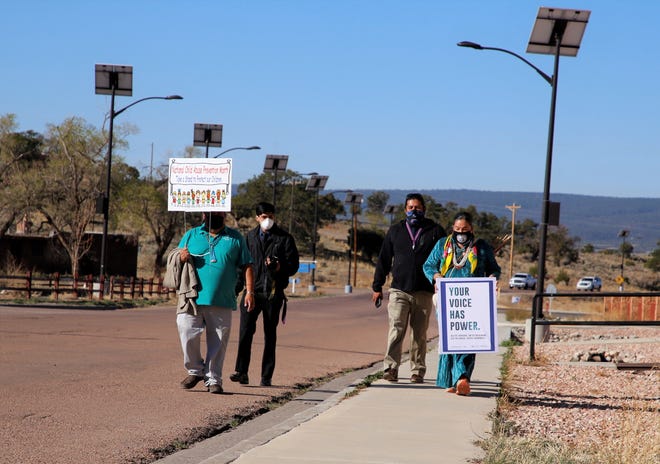 Participants in an awareness walk focusing on sexual assault proceed to the Navajo Nation Council chamber on April 19 in Window Rock, Arizona.